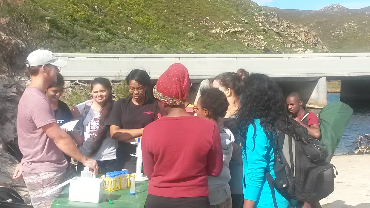 Reuben explaining the use of a portable spectrophotometer.jpg