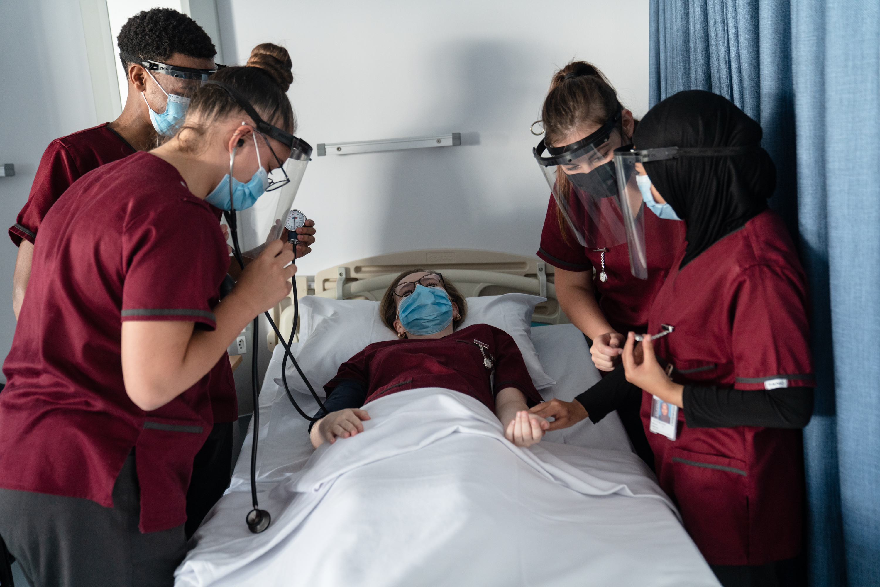 Nursing students practice checking vital signs