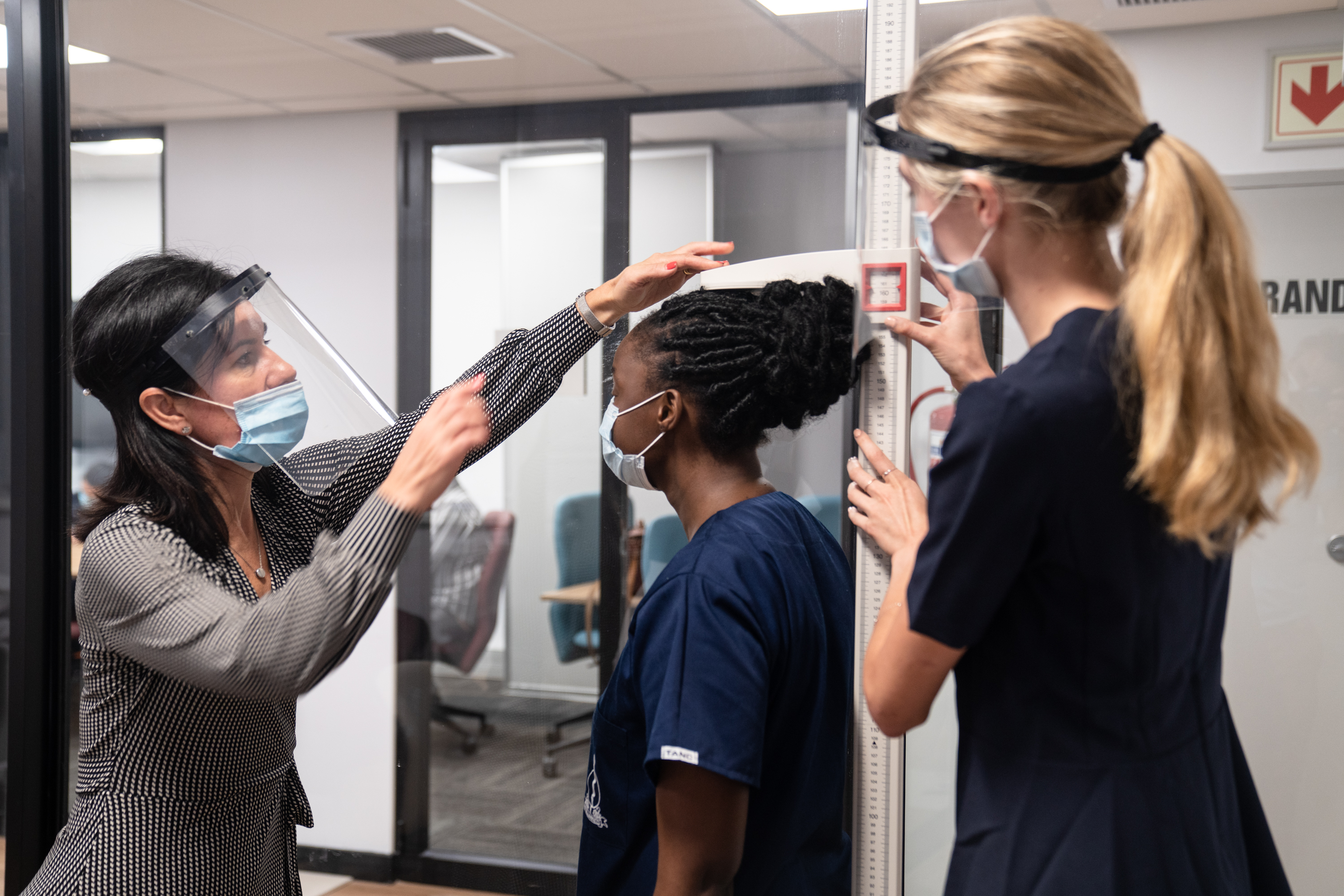 A clinical educator demonstrates the correct method to perform body measurements to Human Nutrition students